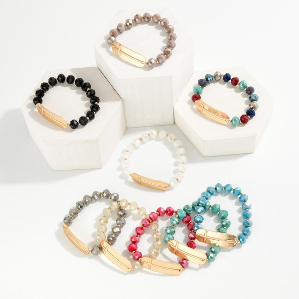 Faceted Bead Beaded Stretch Bracelet Featuring Metal Tone East West Cross

- Approximately 2.5" D