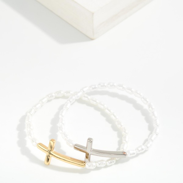 Ringed Pearl Beaded Stretch Bracelet Featuring Metal Tone East West Cross

- Approximately 2.5" D