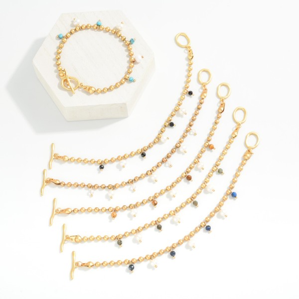 Metal Tone Ball Chain Bracelet Featuring Stone & Pearl Charms With Toggle Clasp 

- Approximately 3" D