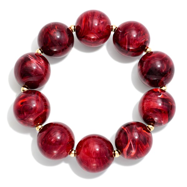 Chunky Resin Bead Stretch Bracelet with oversized marbled beads and tiny metal spacers for a bold, glossy statement. The stretch fit slides right on and stacks easily with bangles and watches. A fun pop for fall sweaters, holiday outfits and weekend looks. Chunky resin bracelets are an easy impulse buy that boutiques sell in multiples.