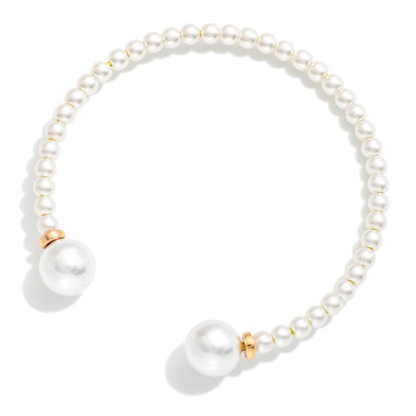 Pearl Bead Cuff Bracelet lined with petite faux pearls and finished with larger pearl ends and polished metal accents. The open cuff design slips on easily and stacks perfectly with chains and bangles. A classic choice for bridal parties, church, the office and everyday polish. Pearl styles are always in demand, and this one makes an easy gift at a friendly price.