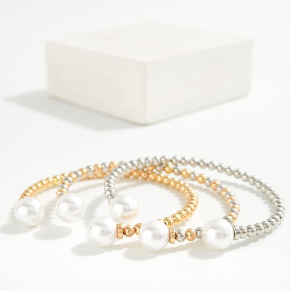 Pearl Tipped Cuff Bracelet with a row of polished metal ball beads finished with a faux pearl at each end. The open cuff slips on easily and adjusts gently for a comfortable fit. Stacks beautifully with bangles and watches or wears alone for a clean, classic look. An easy price point that makes it a natural add on and gift for any age.