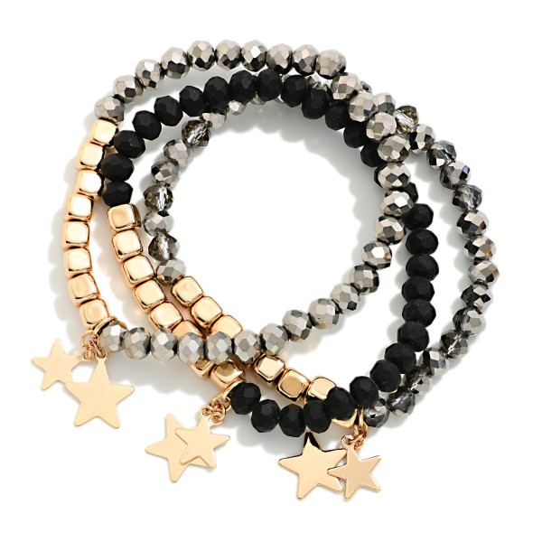 Star Charm Beaded Stretch Bracelet Set featuring strands of faceted glass beads and polished metal beads finished with dangling star charms. The coordinated stack adds sparkle and movement to any outfit and can be worn together or apart. Stretch fit with no clasp. A fun, festive set for holiday gifting and everyday stacking that sells well in multiples.