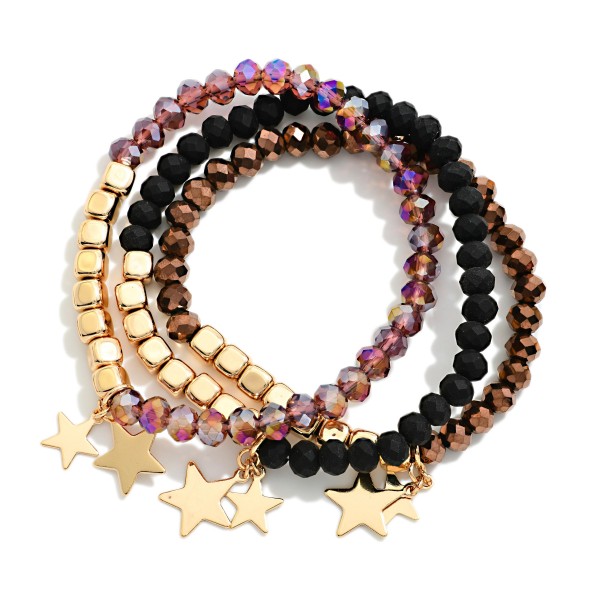 Star Charm Beaded Stretch Bracelet Set featuring strands of faceted glass beads and polished metal beads finished with dangling star charms. The coordinated stack adds sparkle and movement to any outfit and can be worn together or apart. Stretch fit with no clasp. A fun, festive set for holiday gifting and everyday stacking that sells well in multiples.