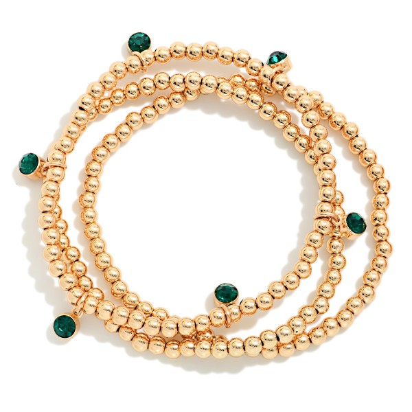 Metal Bead Stretch Bracelet Set featuring strands of polished round beads accented with sparkling bezel set crystals. The stackable strands can be worn together for a full look or mixed into an existing bracelet stack. Comfortable stretch fit with no clasp. A festive, easy gift for the holidays and an everyday stacking staple that appeals to every age.