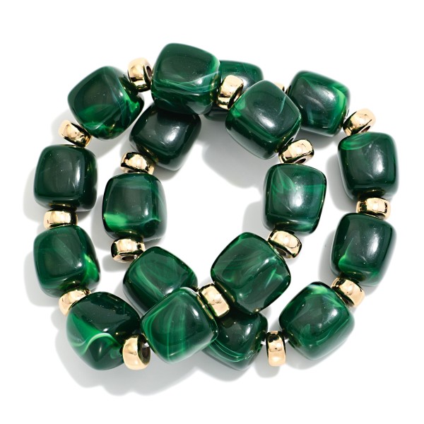 Chunky Marbled Resin Bead Stretch Bracelet featuring oversized cube beads with a swirled, glossy finish separated by polished metal rondelles. The bold beads make a statement on their own or stack easily with bangles and watches. Comfortable stretch fit slides on with no clasp. A trend forward, affordable style that coordinates with fall and holiday wardrobes and sells quickly when displayed in multiples.