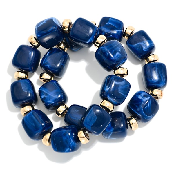 Chunky Marbled Resin Bead Stretch Bracelet featuring oversized cube beads with a swirled, glossy finish separated by polished metal rondelles. The bold beads make a statement on their own or stack easily with bangles and watches. Comfortable stretch fit slides on with no clasp. A trend forward, affordable style that coordinates with fall and holiday wardrobes and sells quickly when displayed in multiples.