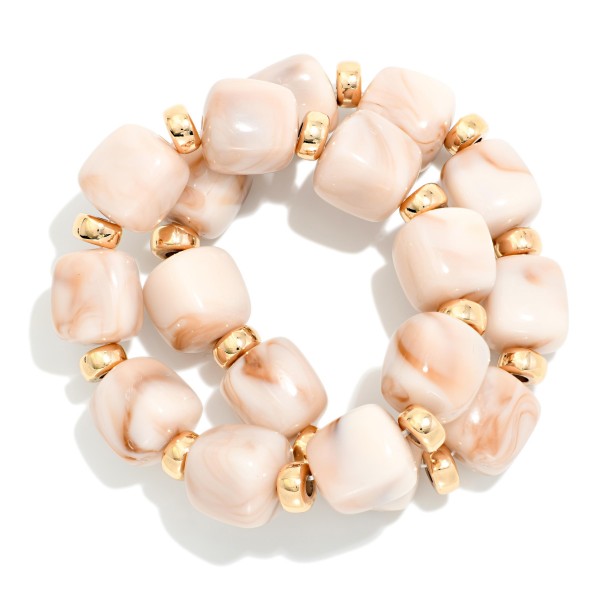 Chunky Marbled Resin Bead Stretch Bracelet featuring oversized cube beads with a swirled, glossy finish separated by polished metal rondelles. The bold beads make a statement on their own or stack easily with bangles and watches. Comfortable stretch fit slides on with no clasp. A trend forward, affordable style that coordinates with fall and holiday wardrobes and sells quickly when displayed in multiples.