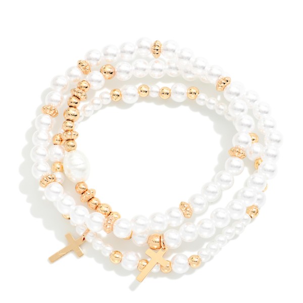 Pearl Cross Charm Stretch Bracelet Set featuring strands of faux pearls accented with sparkling rhinestone rondelles and dangling cross charms. Wear them together for a layered stack or mix with other bracelets for a personalized look. Comfortable stretch fit with no clasp. A beautiful faith gift for baptisms, first communions, Easter, and Mother's Day that sells well year round.