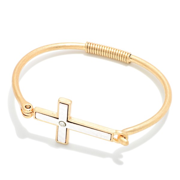 Sideways Cross Wire Bangle Bracelet featuring a polished east west cross centered on a slim wire band with a coiled wrap detail. The hook closure makes it easy to put on and take off. A subtle, meaningful faith piece that stacks beautifully with other bangles. An affordable gift for baptisms, confirmations, and Easter, and a reliable everyday seller.