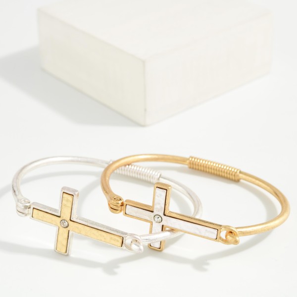 Sideways Cross Wire Bangle Bracelet featuring a polished east west cross centered on a slim wire band with a coiled wrap detail. The hook closure makes it easy to put on and take off. A subtle, meaningful faith piece that stacks beautifully with other bangles. An affordable gift for baptisms, confirmations, and Easter, and a reliable everyday seller.