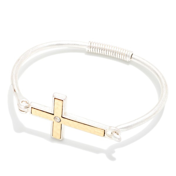 Sideways Cross Wire Bangle Bracelet featuring a polished east west cross centered on a slim wire band with a coiled wrap detail. The hook closure makes it easy to put on and take off. A subtle, meaningful faith piece that stacks beautifully with other bangles. An affordable gift for baptisms, confirmations, and Easter, and a reliable everyday seller.