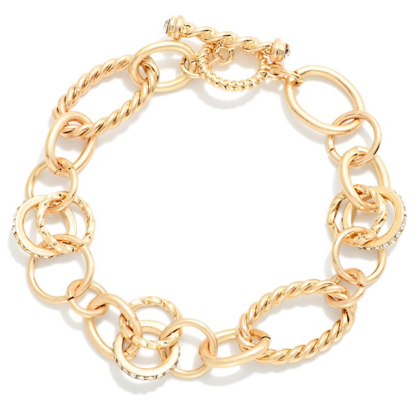 Mixed Link Toggle Bracelet combining smooth and twisted rope oval links with subtle sparkling accents. A front toggle closure adds a modern finishing touch and makes it easy to wear. Pairs with the coordinating mixed link necklace for a matching set. A versatile chain bracelet that stacks well with bangles and watches and works for everyday wear.