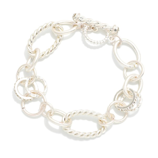 Mixed Link Toggle Bracelet combining smooth and twisted rope oval links with subtle sparkling accents. A front toggle closure adds a modern finishing touch and makes it easy to wear. Pairs with the coordinating mixed link necklace for a matching set. A versatile chain bracelet that stacks well with bangles and watches and works for everyday wear.