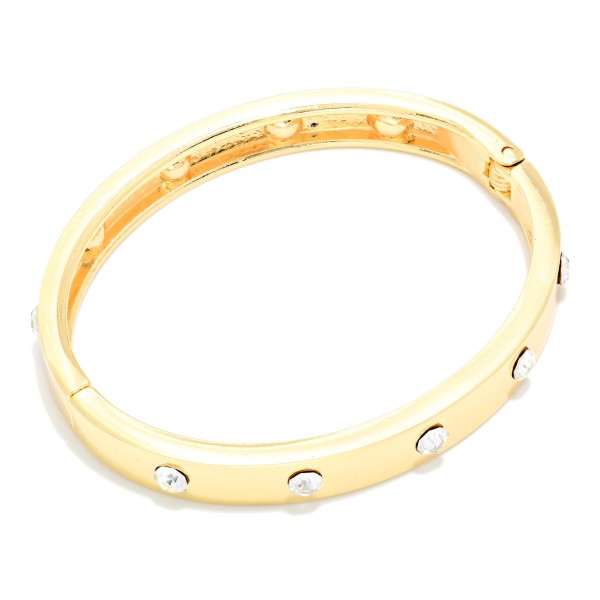 Studded Hinged Bangle Bracelet with a slim polished band accented by evenly spaced round studs. The hinged design opens for easy on and off and closes securely. A refined, stackable bangle that pairs with watches, beaded bracelets, and chunkier cuffs. Simple, versatile, and affordable, it's an easy everyday seller and a thoughtful gift for any occasion.