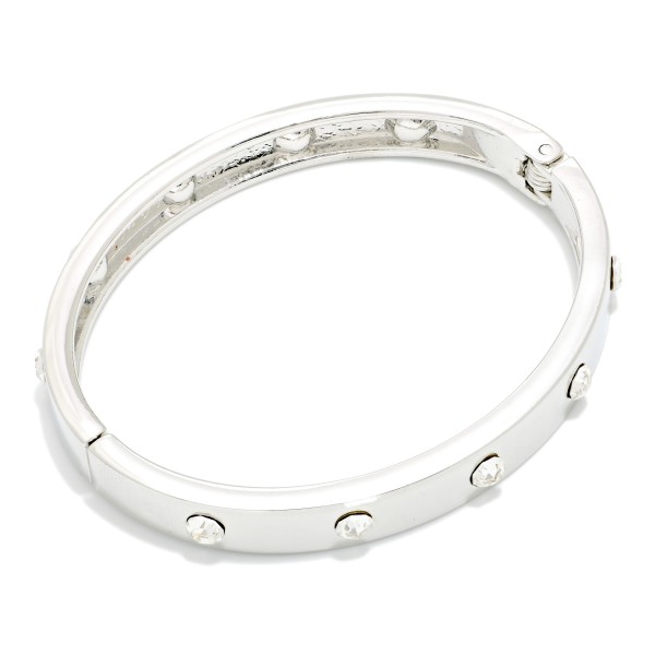Studded Hinged Bangle Bracelet with a slim polished band accented by evenly spaced round studs. The hinged design opens for easy on and off and closes securely. A refined, stackable bangle that pairs with watches, beaded bracelets, and chunkier cuffs. Simple, versatile, and affordable, it's an easy everyday seller and a thoughtful gift for any occasion.