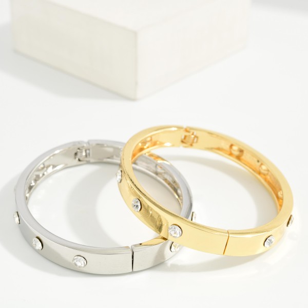 Studded Hinged Bangle Bracelet with a slim polished band accented by evenly spaced round studs. The hinged design opens for easy on and off and closes securely. A refined, stackable bangle that pairs with watches, beaded bracelets, and chunkier cuffs. Simple, versatile, and affordable, it's an easy everyday seller and a thoughtful gift for any occasion.