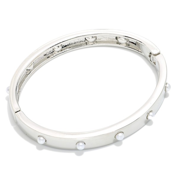 Studded Hinged Bangle Bracelet with a slim polished band accented by evenly spaced round studs. The hinged design opens for easy on and off and closes securely. A refined, stackable bangle that pairs with watches, beaded bracelets, and chunkier cuffs. Simple, versatile, and affordable, it's an easy everyday seller and a thoughtful gift for any occasion.
