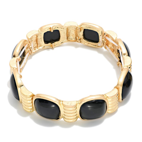 Marbled Stone Stretch Bracelet featuring cushion cut stones with a swirled, glossy finish set between ribbed metal spacers. The stretch fit slides on easily and sits comfortably on most wrists. The bold stones give it a vintage inspired, statement look that pairs well with knits and holiday dresses. Offered in several stone options, it's an easy seller for stacking and coordinating displays.