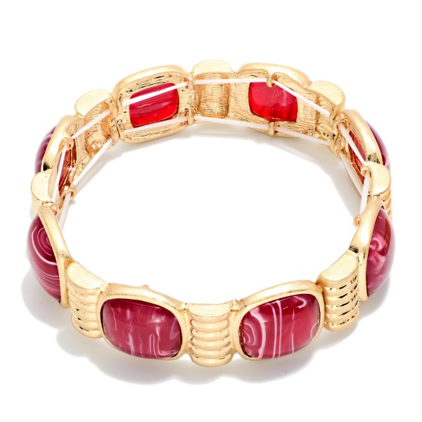 Marbled Stone Stretch Bracelet featuring cushion cut stones with a swirled, glossy finish set between ribbed metal spacers. The stretch fit slides on easily and sits comfortably on most wrists. The bold stones give it a vintage inspired, statement look that pairs well with knits and holiday dresses. Offered in several stone options, it's an easy seller for stacking and coordinating displays.