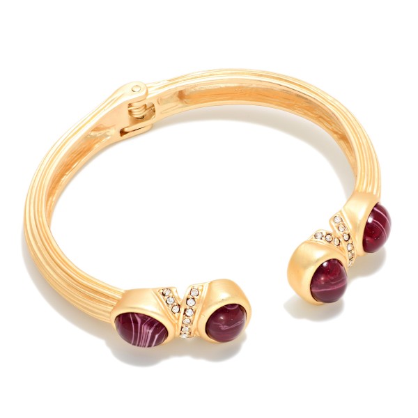 Stone Tip Open Cuff Bracelet featuring a ribbed matte band with round cabochon stones at each end and sparkling rhinestone accents. The open cuff design slips on easily and adjusts to most wrists. Bold enough to wear alone yet easy to stack with bangles and watches. A polished statement cuff that makes a great holiday gift and an easy upsell for customers shopping your bracelet display.