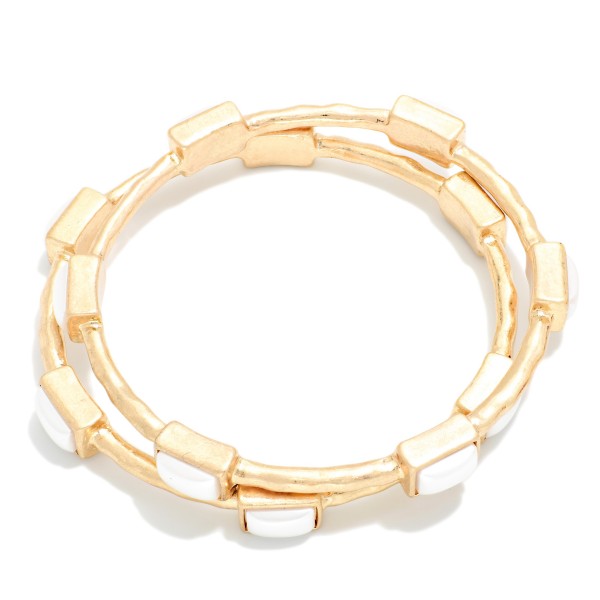 Framed Stone Station Bangle Bracelet with polished square stones set along slim wire bands for an easy stacked look. The clean framed settings give it a refined, vintage inspired finish that dresses up everyday outfits. Slips on easily and pairs well with watches and stretch styles. Offered in a wide range of stone options, it's perfect for building a coordinated bangle display and encouraging multiple purchases.
