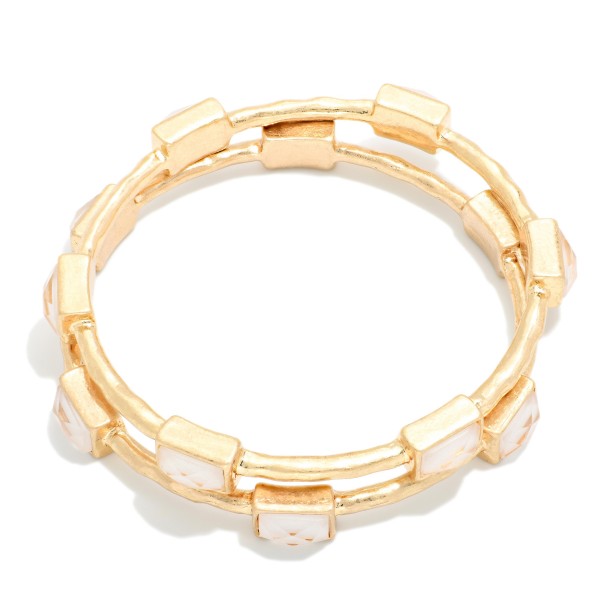 Framed Stone Station Bangle Bracelet with polished square stones set along slim wire bands for an easy stacked look. The clean framed settings give it a refined, vintage inspired finish that dresses up everyday outfits. Slips on easily and pairs well with watches and stretch styles. Offered in a wide range of stone options, it's perfect for building a coordinated bangle display and encouraging multiple purchases.