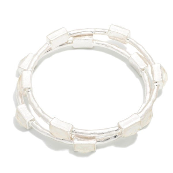 Framed Stone Station Bangle Bracelet with polished square stones set along slim wire bands for an easy stacked look. The clean framed settings give it a refined, vintage inspired finish that dresses up everyday outfits. Slips on easily and pairs well with watches and stretch styles. Offered in a wide range of stone options, it's perfect for building a coordinated bangle display and encouraging multiple purchases.