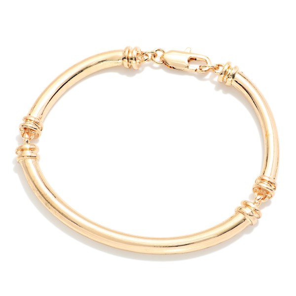 Polished Tube Hinged Bangle Bracelet with a smooth, rounded profile and ribbed accents at the hinge. The hinged design opens wide for easy on and off and closes securely. A clean, classic bangle that stacks well with watches, beaded stretch bracelets, and charm styles. Timeless and versatile, it's an easy everyday seller for customers of all ages.