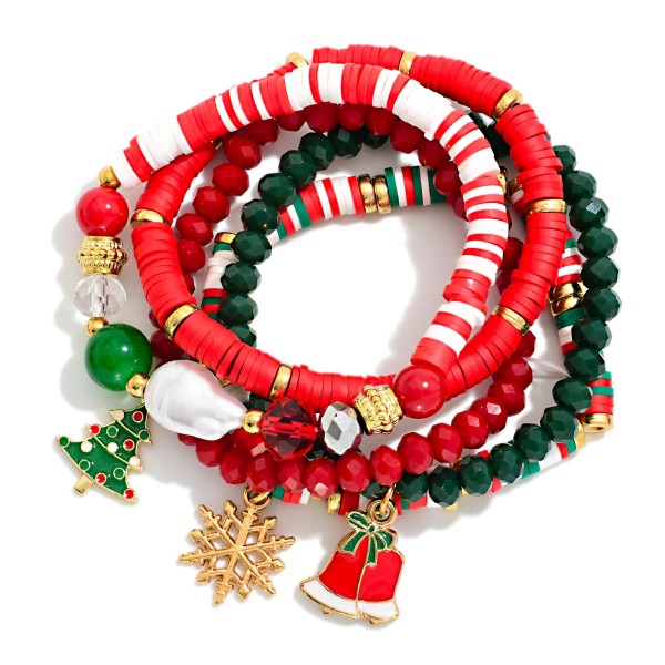 Holiday Heishi Stretch Bracelet Set with a stack of polymer clay heishi, faceted crystal, and accent bead strands finished with festive charms, including a Christmas tree, a snowflake, a jingle bell, and a baroque style pearl. The striped heishi strand brings a playful candy cane look, while the stretch fit slips on easily and layers with watches and everyday bangles. Perfect for holiday parties, teacher gifts, and stocking stuffers. A full stack at a friendly price point that turns quickly through the season.