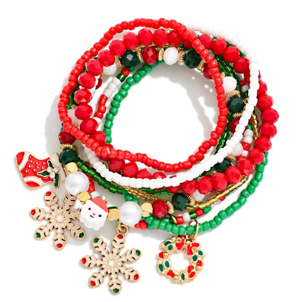 Christmas Charm Beaded Stretch Bracelet Set with a full stack of seed bead, faceted crystal, and pearl strands finished with festive enamel charms, including a stocking, Santa, snowflakes, and a holly wreath. Every strand stretches to slip on easily, so shoppers can wear the whole stack or split strands to mix with everyday pieces. A ready made holiday look for parties, school events, and gift exchanges. Packed with value at an easy price, stacks like this sell through fast all season.