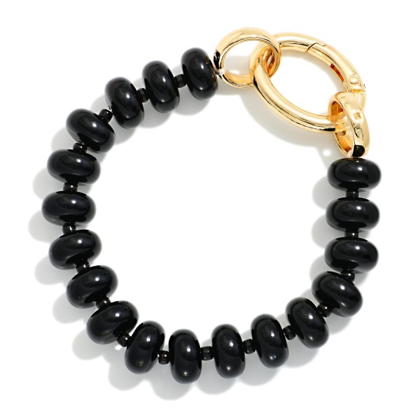 Rondelle Bead Bracelet with an oversized statement clasp, strung with smooth, glossy beads for a polished modern look. The chunky lock style closure is both functional and decorative, adding a trendy hardware detail that stands out in any stack. Easy to fasten on your own and comfortable for everyday wear. Hardware inspired jewelry is trending, and this bracelet gives shoppers that look at a friendly price.