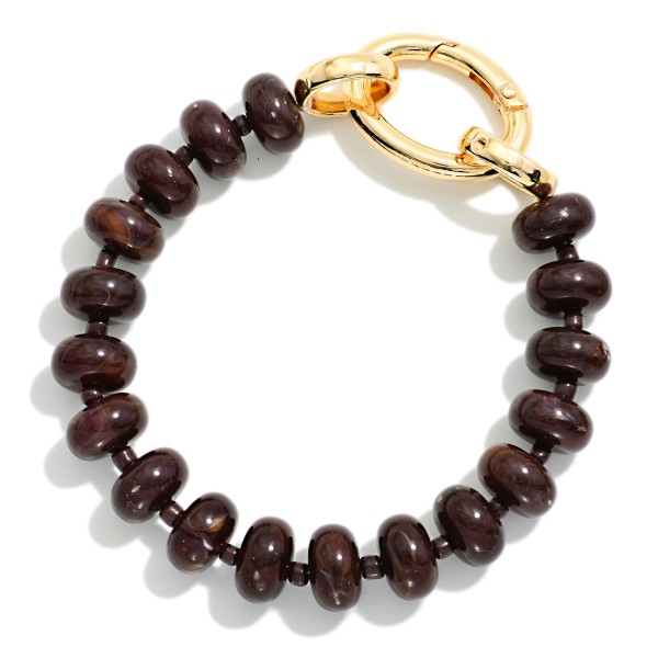 Rondelle Bead Bracelet with an oversized statement clasp, strung with smooth, glossy beads for a polished modern look. The chunky lock style closure is both functional and decorative, adding a trendy hardware detail that stands out in any stack. Easy to fasten on your own and comfortable for everyday wear. Hardware inspired jewelry is trending, and this bracelet gives shoppers that look at a friendly price.