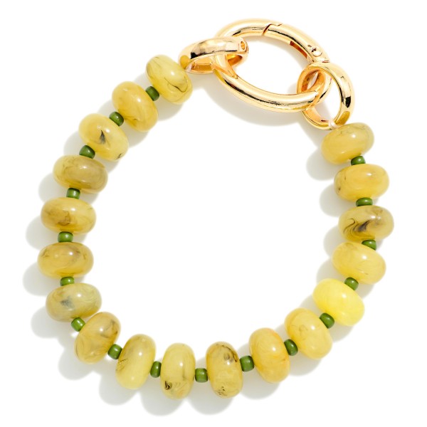 Rondelle Bead Bracelet with an oversized statement clasp, strung with smooth, glossy beads for a polished modern look. The chunky lock style closure is both functional and decorative, adding a trendy hardware detail that stands out in any stack. Easy to fasten on your own and comfortable for everyday wear. Hardware inspired jewelry is trending, and this bracelet gives shoppers that look at a friendly price.