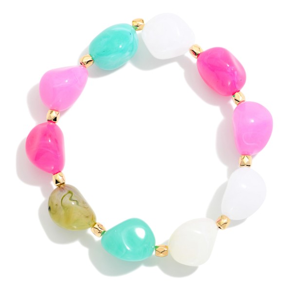 Chunky Resin Nugget Stretch Bracelet with glossy, organically shaped beads and small metal spacer accents. The playful mix of stones adds a cheerful pop to everything from summer dresses to cozy winter knits. Elastic stretch construction slides on easily and fits most wrists. Wear it alone or pile it into a stack. Fun, chunky stackers are an easy impulse buy and a crowd pleaser for gift shops and boutiques alike.