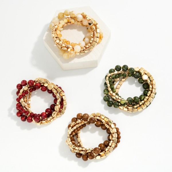Stackable Stretch Bracelet Set mixing round stone look beads, polished metal cubes, and flat metal discs in one coordinated stack. The blend of textures creates an effortless layered look straight out of the package, and each strand can be worn alone too. Elastic construction slips on easily and fits most wrists. Ready made stacks are one of the fastest turning bracelet styles, offering shoppers a complete look at a great value.
