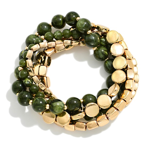 Stackable Stretch Bracelet Set mixing round stone look beads, polished metal cubes, and flat metal discs in one coordinated stack. The blend of textures creates an effortless layered look straight out of the package, and each strand can be worn alone too. Elastic construction slips on easily and fits most wrists. Ready made stacks are one of the fastest turning bracelet styles, offering shoppers a complete look at a great value.