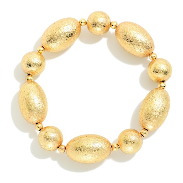 Textured Metal Bead Stretch Bracelet with oversized oval beads finished in a brushed, ridged texture for subtle shine. The stretch fit slips on easily and makes a bold statement on its own or stacked with other bracelets. Great for work, weekends, and holiday outfits. A modern, versatile metal bracelet that appeals to a broad range of customers and sells well all year.