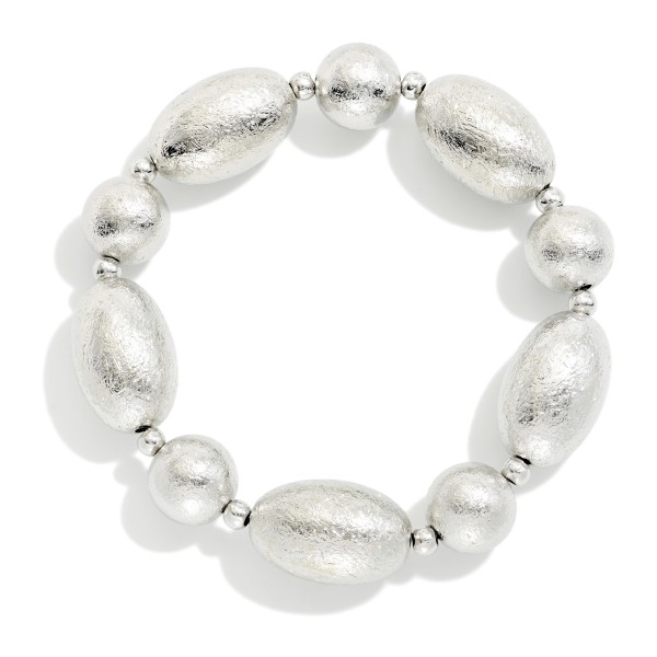 Textured Metal Bead Stretch Bracelet with oversized oval beads finished in a brushed, ridged texture for subtle shine. The stretch fit slips on easily and makes a bold statement on its own or stacked with other bracelets. Great for work, weekends, and holiday outfits. A modern, versatile metal bracelet that appeals to a broad range of customers and sells well all year.