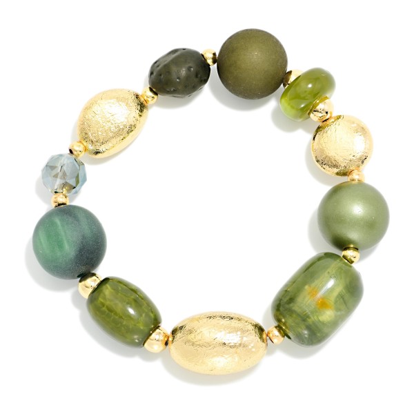 Mixed Bead Stretch Bracelet combining glossy and matte stone look beads with textured metal accent beads in varied sizes. The chunky, organic mix adds earthy texture to fall outfits and stacks well with bangles and watches. A stretch fit makes it easy to slip on and off. Coordinates with the mixed bead statement necklaces for an easy add on sale at the register.