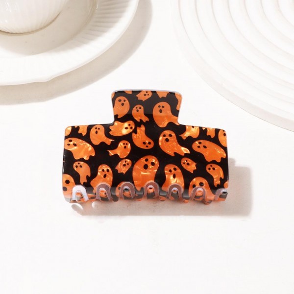 Halloween print claw clip molded in glossy acrylic with an allover ghost motif and deep teeth that hold a full twist of thick hair. Wide enough to do real work at the back of the head while still reading as a costume detail. The printed finish makes an everyday clip feel seasonal without committing to a full look. Halloween hair pieces are a proven September and October impulse buy at the register.