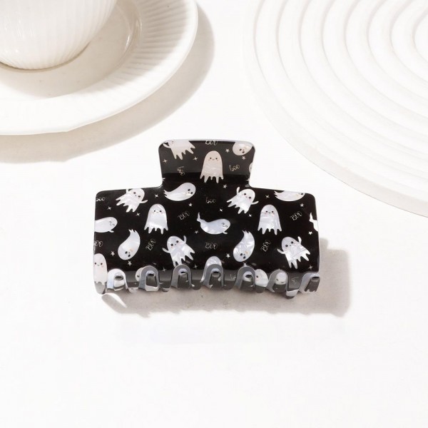 Halloween print claw clip molded in glossy acrylic with an allover ghost motif and deep teeth that hold a full twist of thick hair. Wide enough to do real work at the back of the head while still reading as a costume detail. The printed finish makes an everyday clip feel seasonal without committing to a full look. Halloween hair pieces are a proven September and October impulse buy at the register.