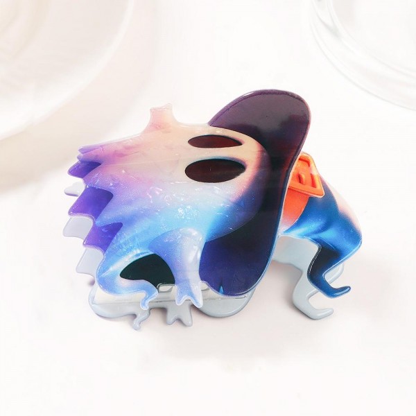 Ghost-shaped claw hair clip molded in glossy acrylic with a soft marbled ombre finish. Strong-grip teeth hold a twist, a half-up, or a full clip-up on fine and thick hair alike, and the playful spirit silhouette makes it an instant seasonal impulse buy. Scaled for everyday wear rather than costume-only, so it keeps moving from early fall right through October. A low price point, high-turn add for the counter or a themed display.