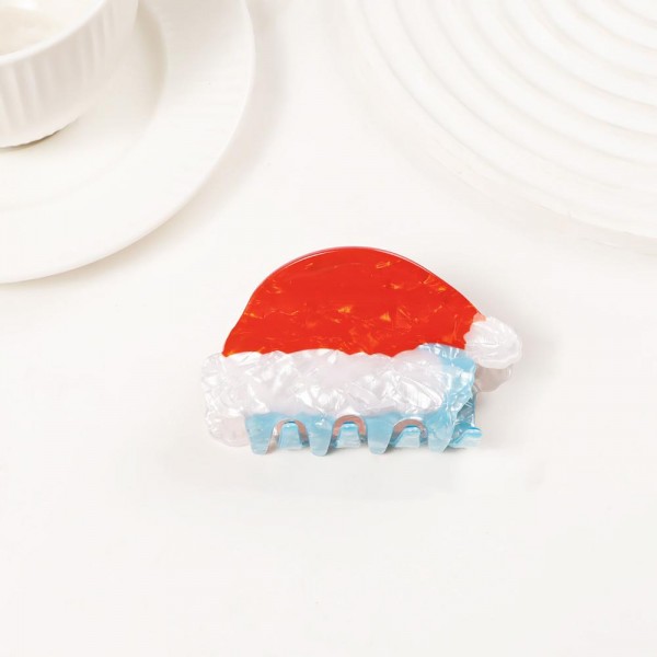 Holiday-shaped claw hair clip molded in glossy acrylic with hand-painted seasonal detail and a glitter-flecked finish. Strong-grip teeth hold a twist, a half-up, or a full clip-up on fine and thick hair alike, so it works for everyday wear and not just the party. A natural stocking stuffer, teacher gift, and secret-santa filler that buyers grab in multiples. Small footprint and low price point make it an easy counter or holiday-display add.
