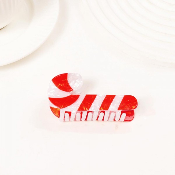 Holiday-shaped claw hair clip molded in glossy acrylic with hand-painted seasonal detail and a glitter-flecked finish. Strong-grip teeth hold a twist, a half-up, or a full clip-up on fine and thick hair alike, so it works for everyday wear and not just the party. A natural stocking stuffer, teacher gift, and secret-santa filler that buyers grab in multiples. Small footprint and low price point make it an easy counter or holiday-display add.