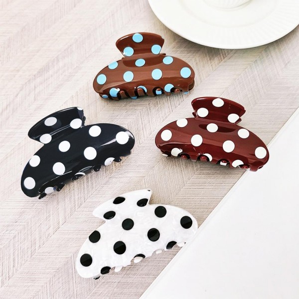 Polka dot claw hair clip in smooth acrylic with contrast painted dots and a mid-size profile. Strong-grip teeth hold a twist, a half-up, or a full clip-up on fine and thick hair alike without pulling or sliding out. Polka dots are a perennial retro print that pairs just as easily with denim and knits as with workwear. A steady everyday seller at an impulse price, and an easy multiple for customers building a clip collection.