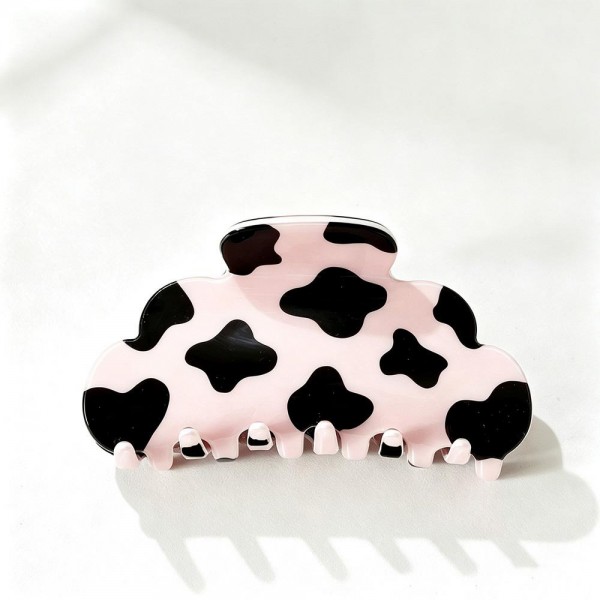 Cow Print Claw Hair Clip with a playful spotted pattern on a smooth, glossy acrylic body. The rounded cloud shape and strong spring hinge grip medium to thick hair for a quick twist, half up look, or messy bun that stays put all day. A trendy pick for western inspired outfits, rodeo season, country concerts, and everyday wear. Easy to merchandise by the dozen, these fun printed clips are a quick impulse buy that customers love to collect.