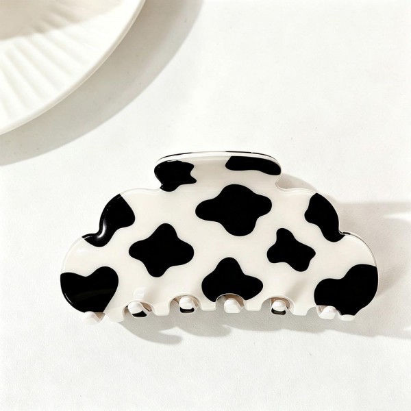 Cow Print Claw Hair Clip with a playful spotted pattern on a smooth, glossy acrylic body. The rounded cloud shape and strong spring hinge grip medium to thick hair for a quick twist, half up look, or messy bun that stays put all day. A trendy pick for western inspired outfits, rodeo season, country concerts, and everyday wear. Easy to merchandise by the dozen, these fun printed clips are a quick impulse buy that customers love to collect.