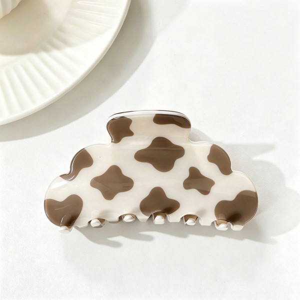 Cow Print Claw Hair Clip with a playful spotted pattern on a smooth, glossy acrylic body. The rounded cloud shape and strong spring hinge grip medium to thick hair for a quick twist, half up look, or messy bun that stays put all day. A trendy pick for western inspired outfits, rodeo season, country concerts, and everyday wear. Easy to merchandise by the dozen, these fun printed clips are a quick impulse buy that customers love to collect.