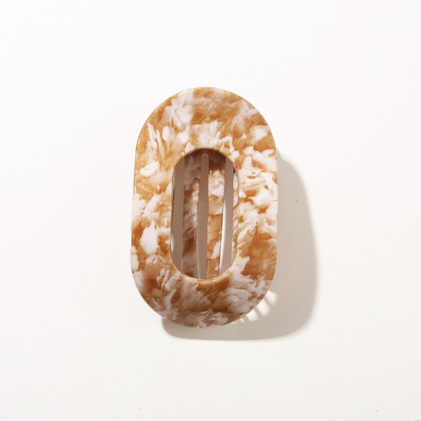Oval hair barrette cut from marbled acrylic with a hidden snap bar that clicks closed over a half up style, a low ponytail, or a loose braid. The resin pattern shifts across the face so no two pieces look exactly alike. Smooth edges keep it from catching on fine hair and it sits flat against the head all day. Marbled barrettes read expensive on a display and move quickly at an impulse price.